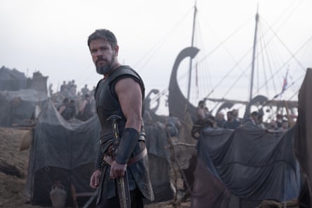 A still of Matt Damon in The Odyssey on the shore in front of boats.