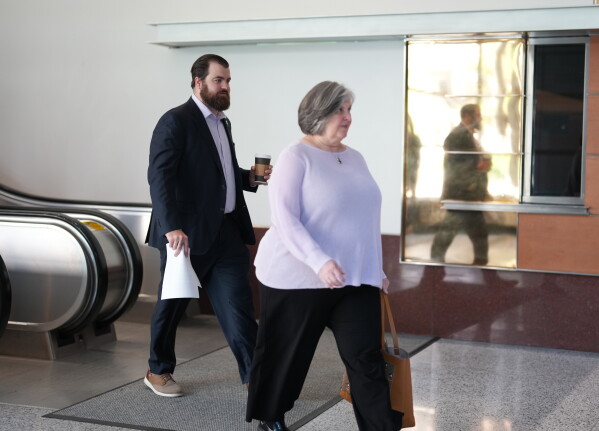 Colin Hortman (left), son of Mark and Melissa Hortman, walks into the lobby of the Diana E. Murphy United States Courthouse before a sentencing hearing for Vance Boelter in Minneapolis, on Thursday, July 23, 2026. (Alex Kormann/Minnesota Star Tribune via AP)