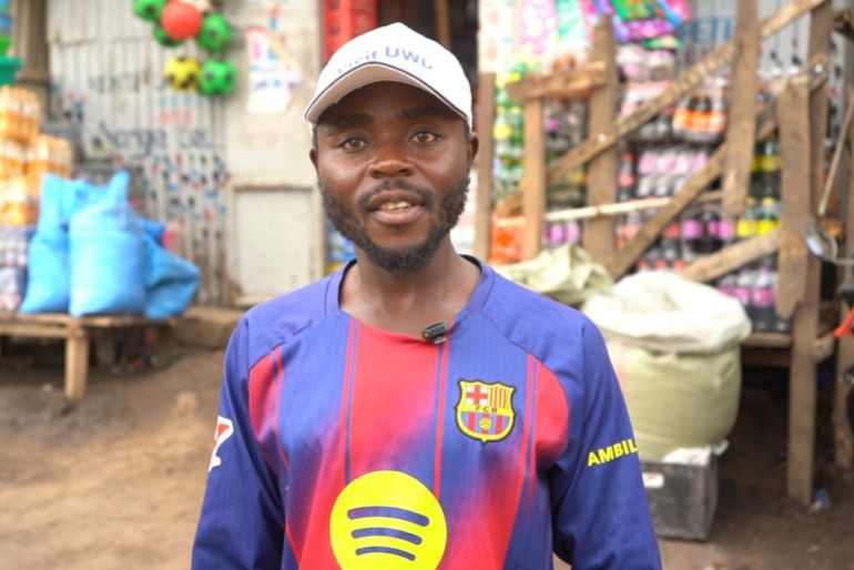 Health worker Paluku Audrey stands at a market in Bunia, Ituri Province. The 29-year-old must enter communities to explain to distrusting residents about the risks of Ebola infection